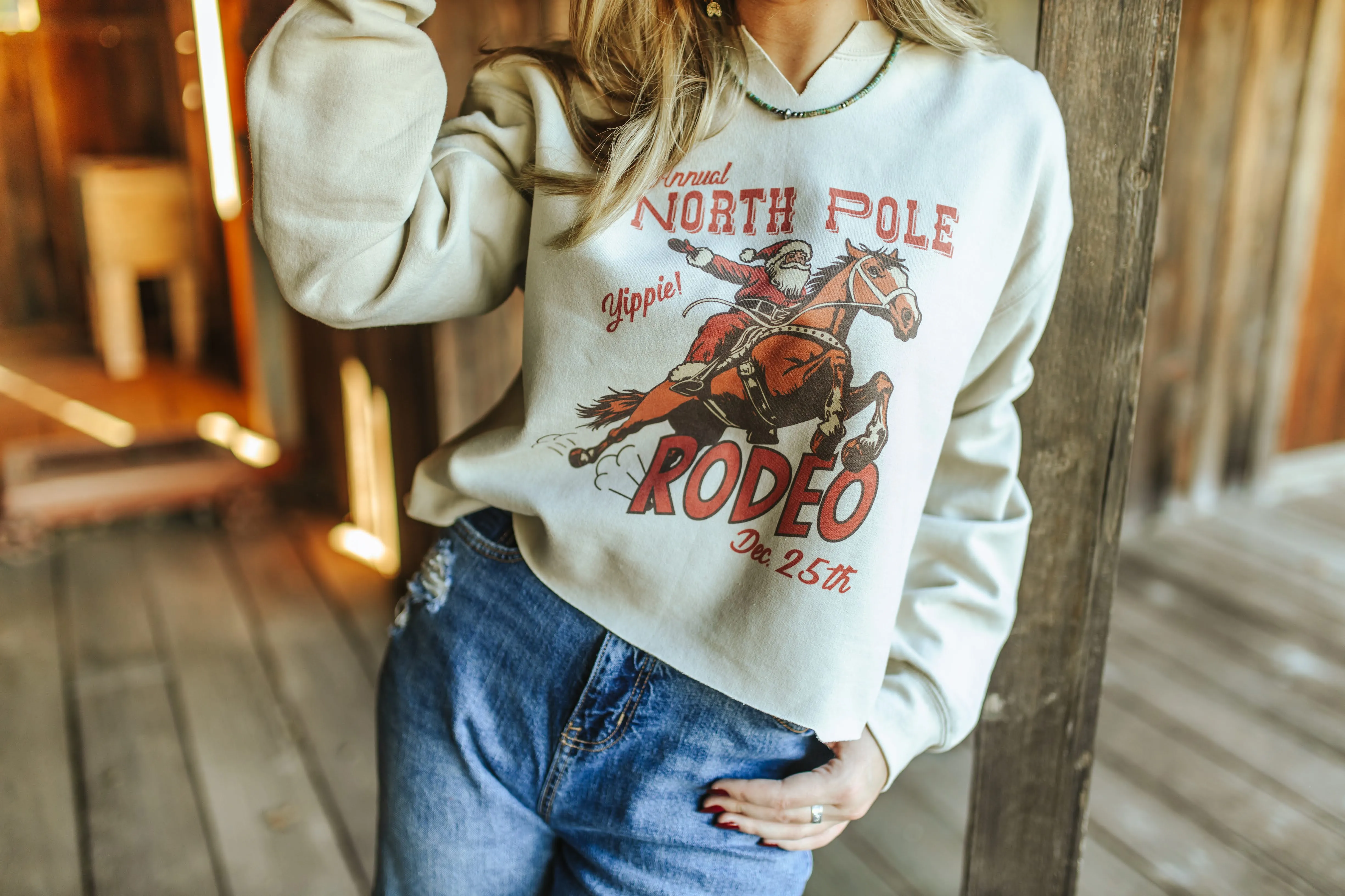 North Pole Rodeo Raw Hem V-Neck Crop Graphic Sweatshirt